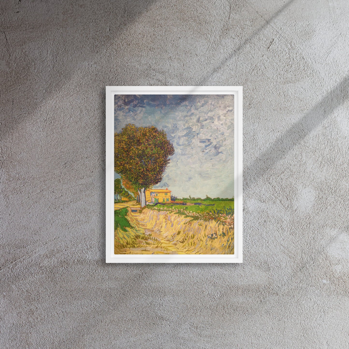 Van Gogh's 'A Lane near Arles' on a 12"x16" white framed canvas print on a textured gray wall.