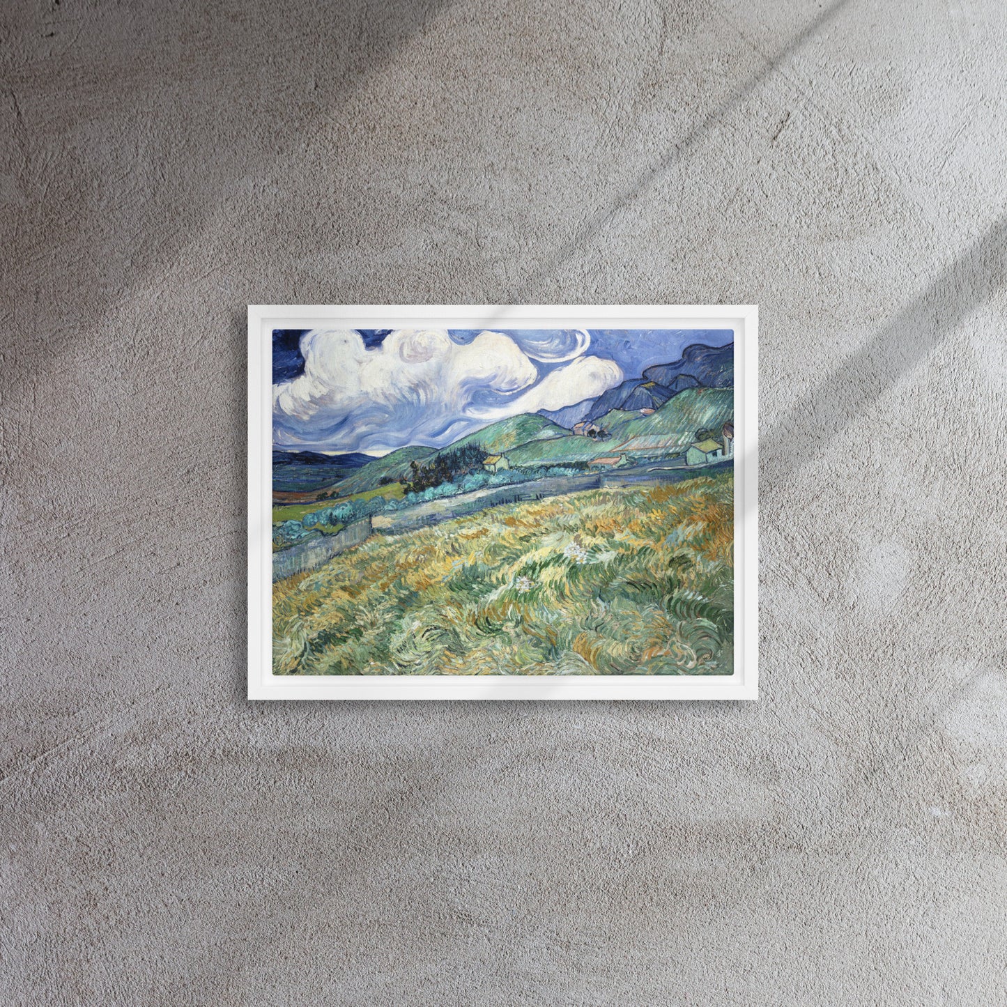 Van Gogh's 'Landscape from Saint-Rémy' on a 12"x16" white framed canvas print on a textured gray wall.