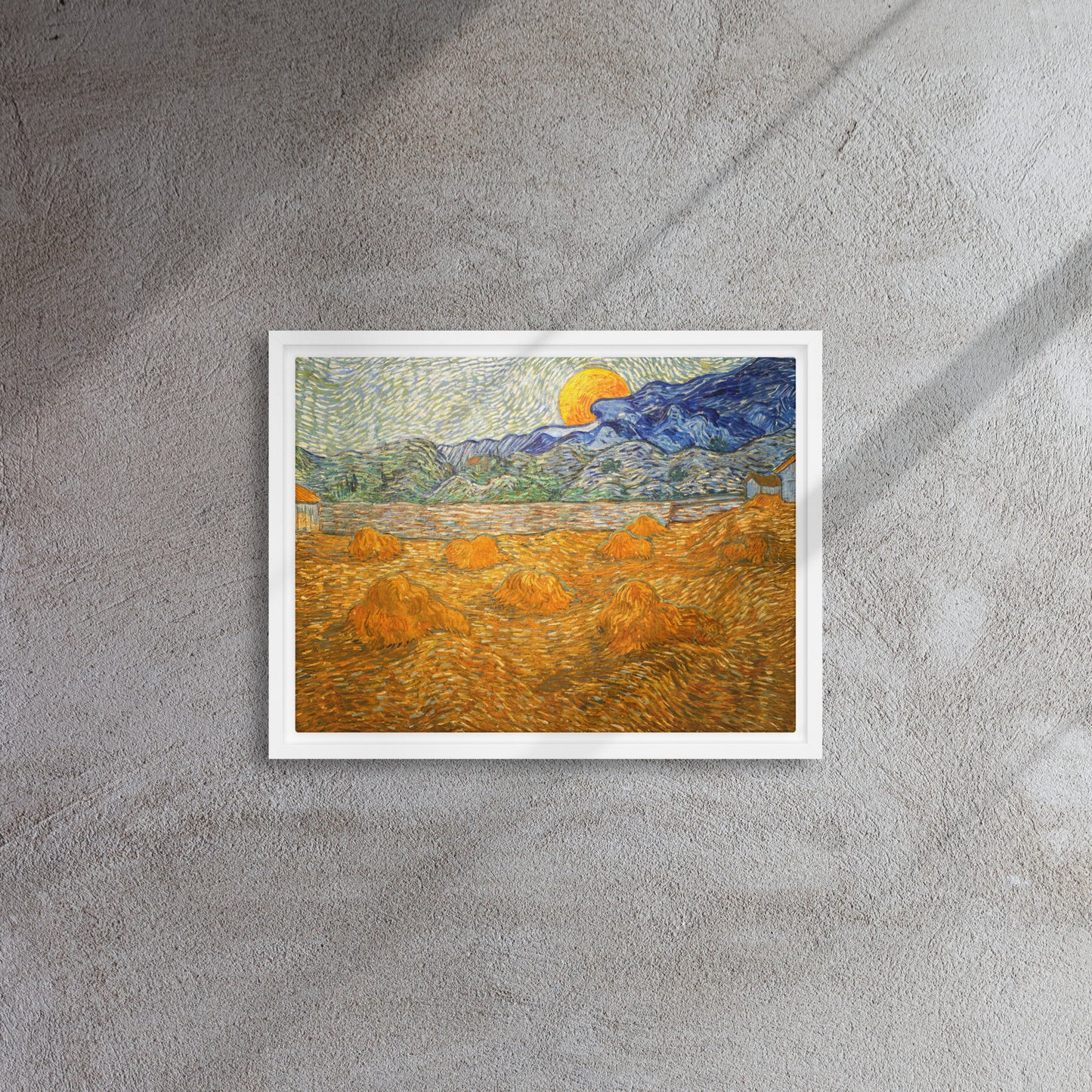 Van Gogh's 'Landscape with Wheat Sheaves and Rising Moon' on a 12"x16" white framed canvas print on a textured gray wall.