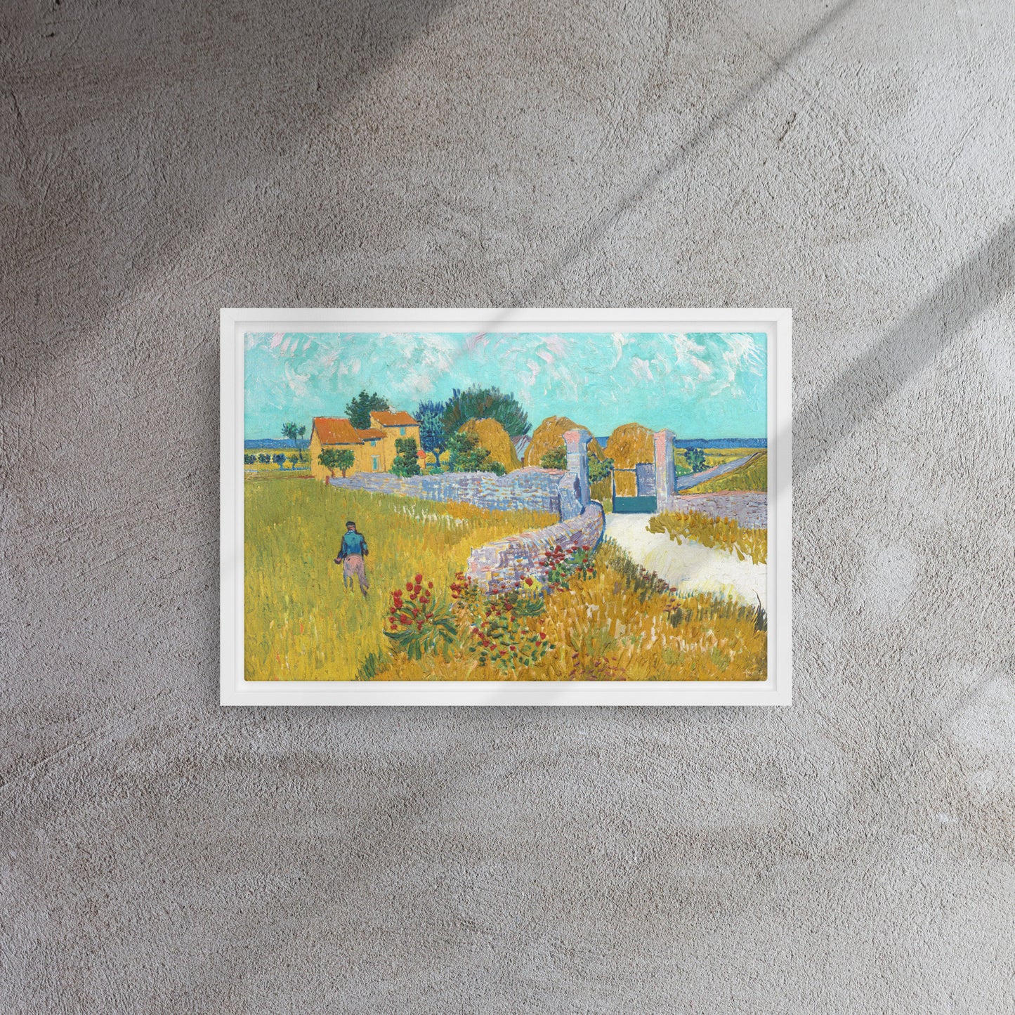 Van Gogh's 'Farmhouse in Provence' on a 12"x18" white framed canvas print on a textured gray wall.