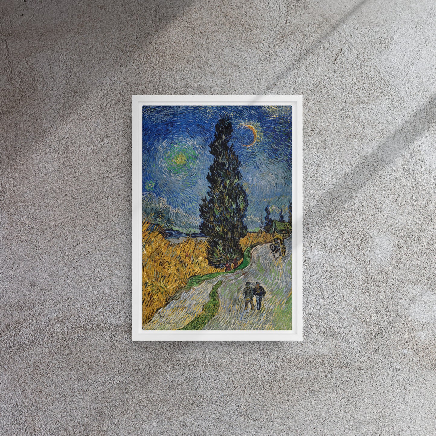 Van Gogh's 'Road with Cypress and Star' on a 12"x18" white framed canvas print on a textured gray wall.