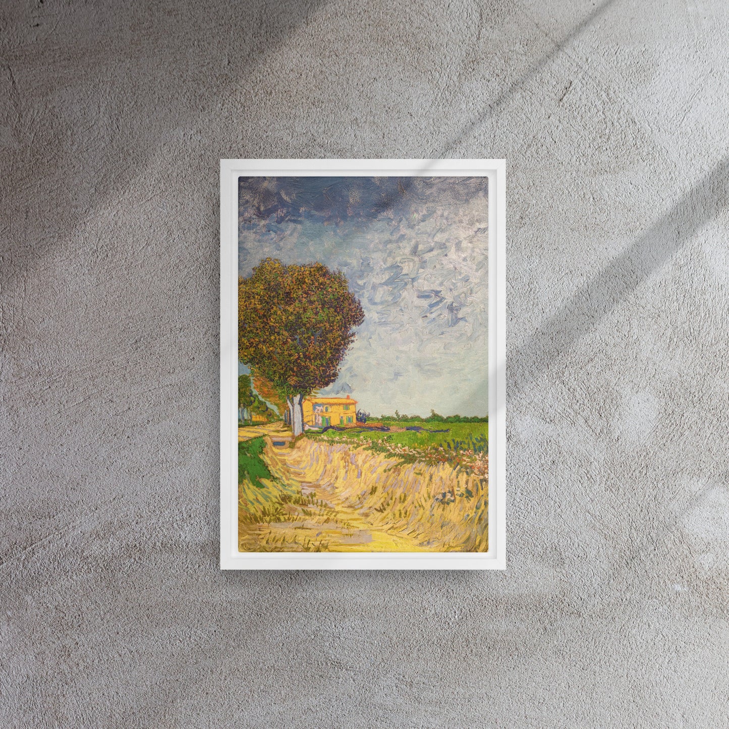 Van Gogh's 'A Lane near Arles' on a 12"x18" white framed canvas print on a textured gray wall.