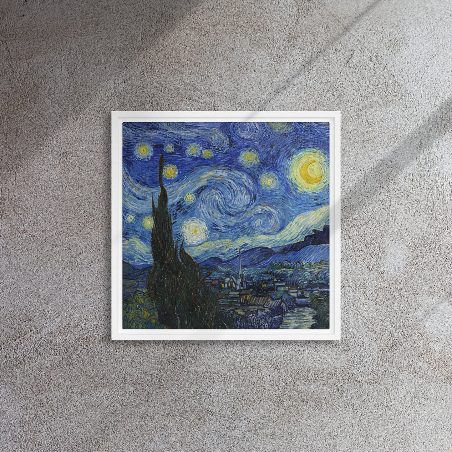 Van Gogh's 'Starry Night' on a 16"x16" white framed canvas print on a textured gray wall.