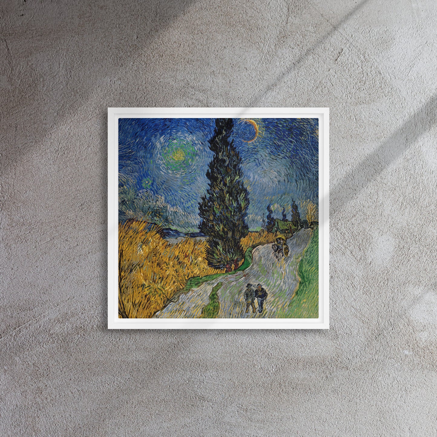 Van Gogh's 'Road with Cypress and Star' on a 16"x16" white framed canvas print on a textured gray wall.