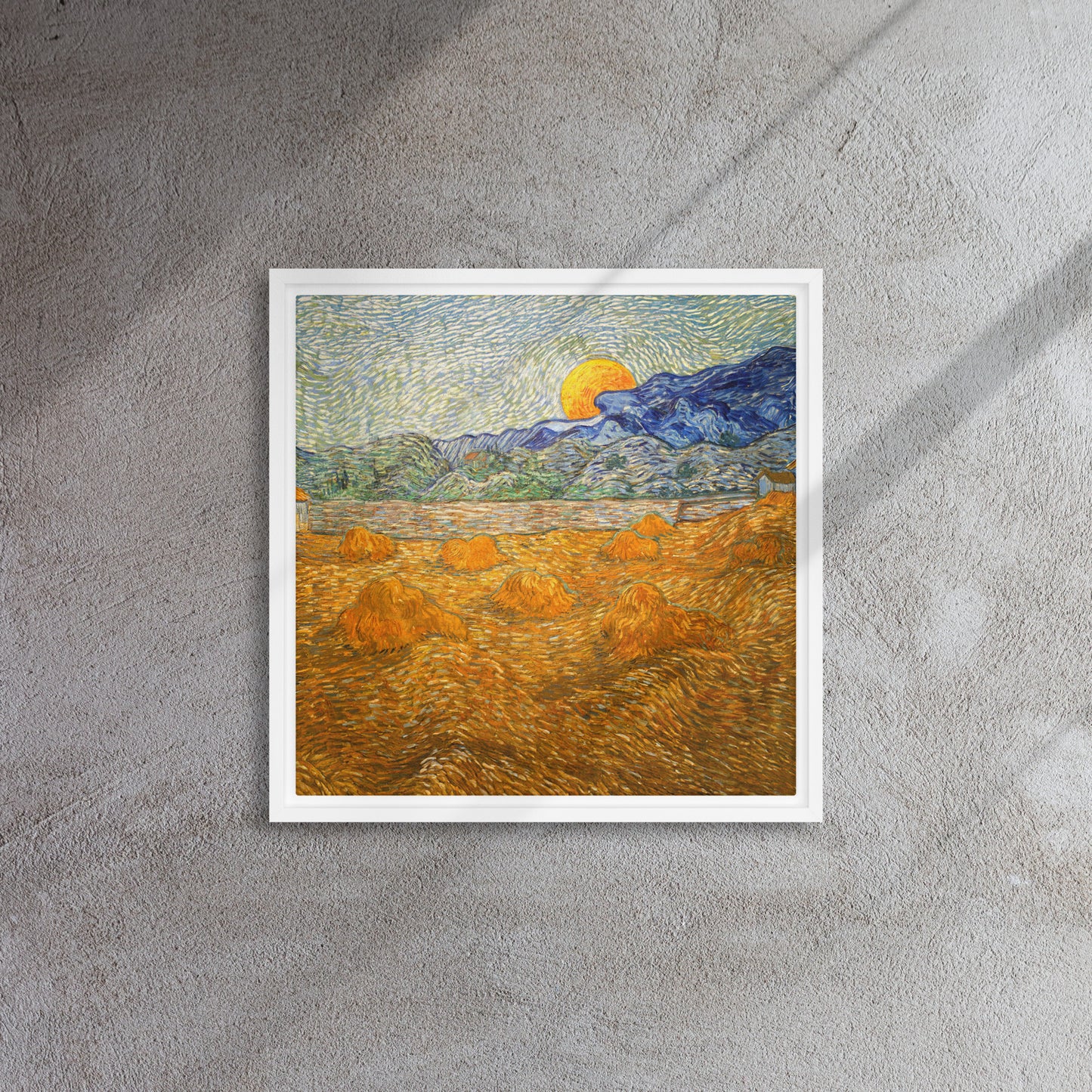 Van Gogh's 'Landscape with Wheat Sheaves and Rising Moon' on a 16"x16" white framed canvas print on a textured gray wall.