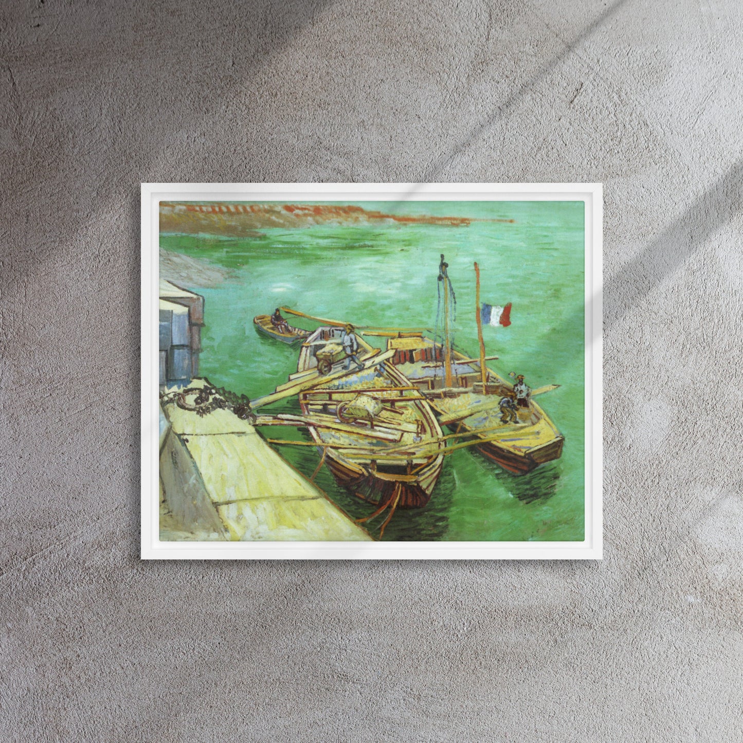 Van Gogh's 'Quay with Men Unloading Sand Barges' on a 16"x20" white framed canvas print on a textured gray wall.
