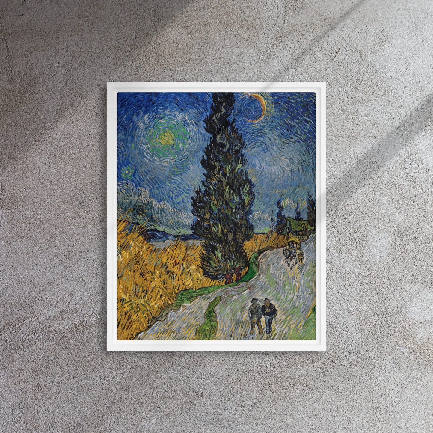 Van Gogh's 'Road with Cypress and Star' on a 16"x20" white framed canvas print on a textured gray wall.