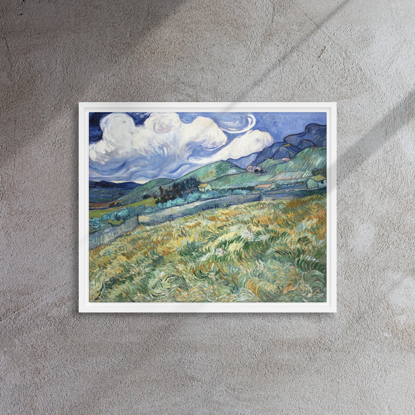 Van Gogh's 'Landscape from Saint-Rémy' on a 16"x20" white framed canvas print on a textured gray wall.