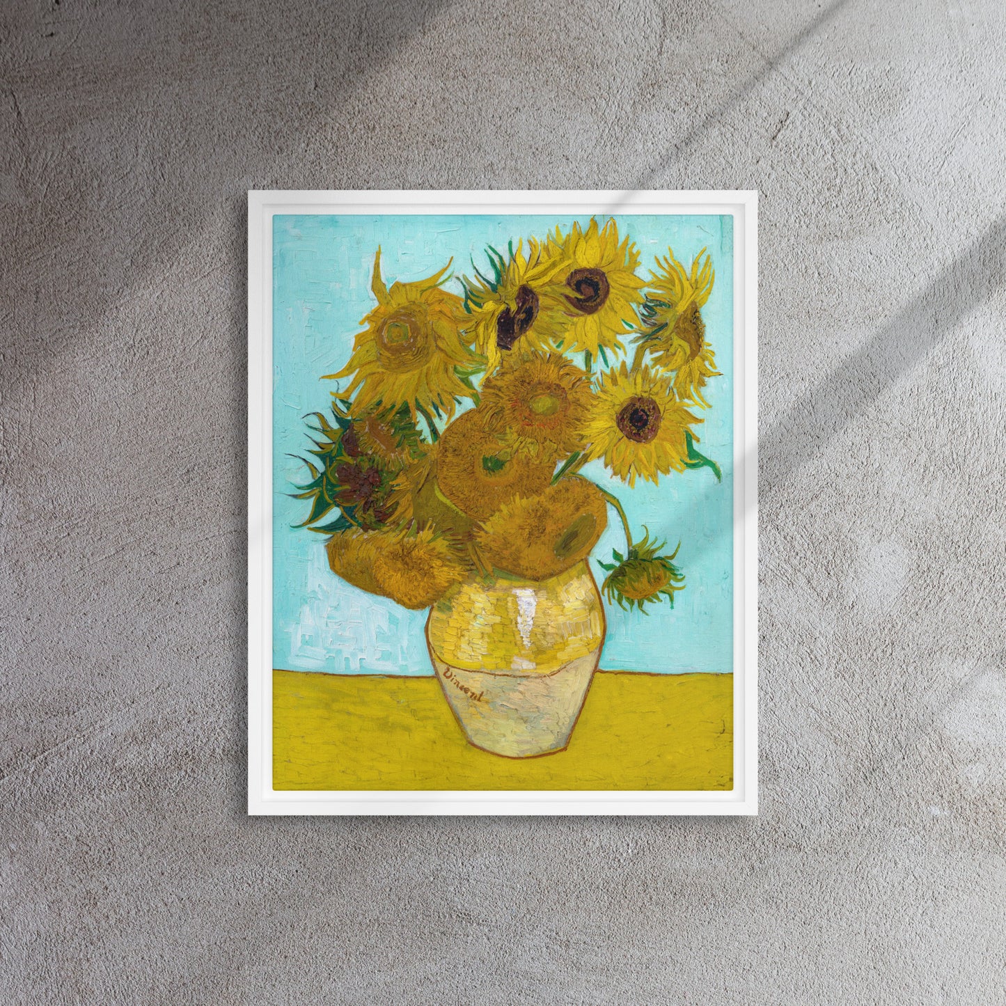 Van Gogh's 'Vase with Twelve Sunflowers' on a 16"x20" white framed canvas print on a textured wall.