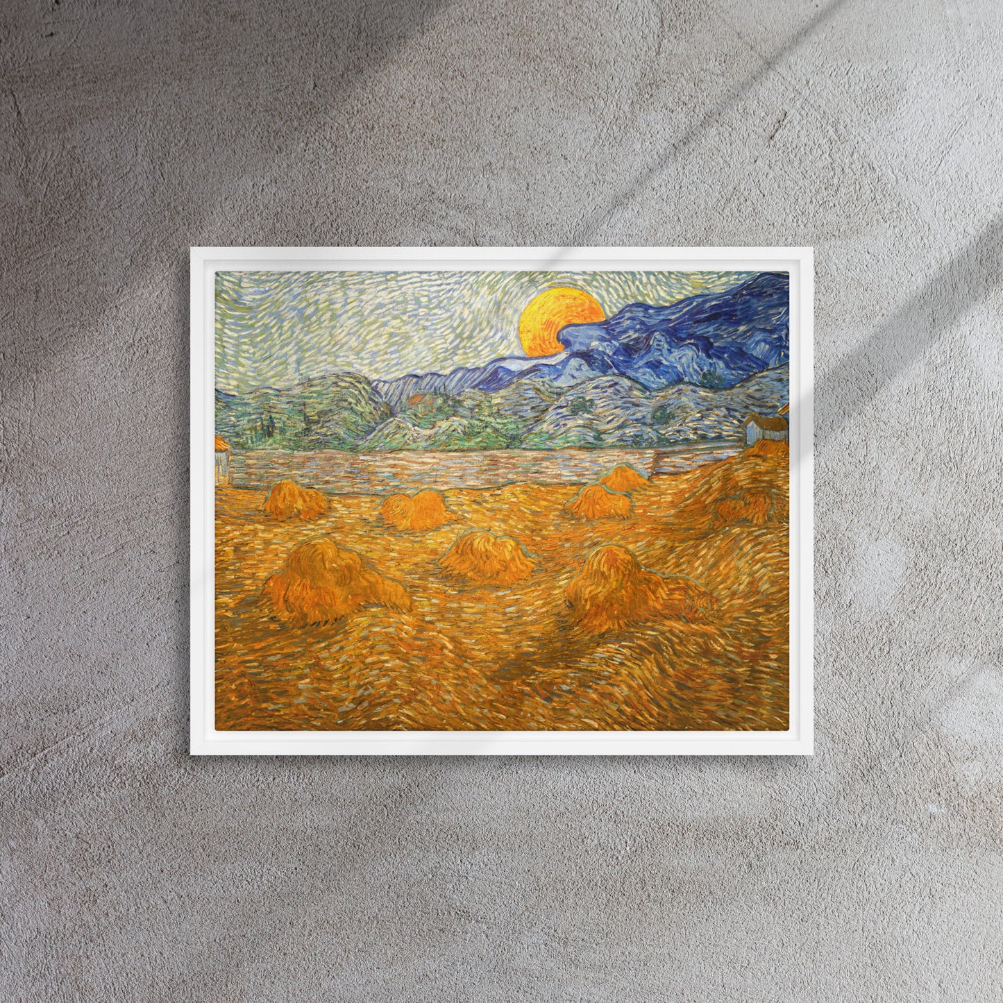 Van Gogh's 'Landscape with Wheat Sheaves and Rising Moon' on a 16"x20" white framed canvas print on a textured gray wall.