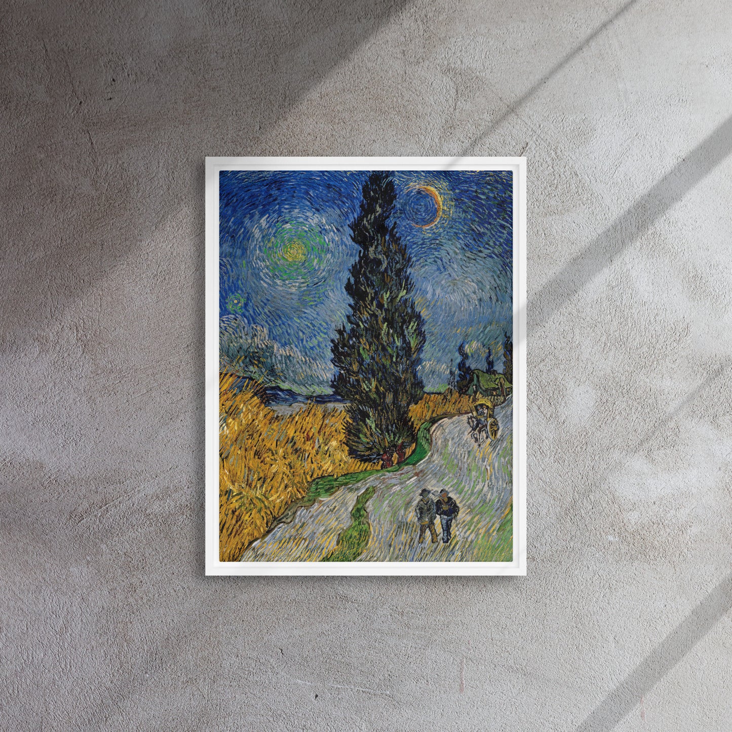 Van Gogh's 'Road with Cypress and Star' on a 18"x24" white framed canvas print on a textured gray wall.