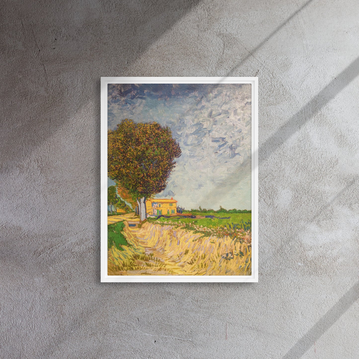 Van Gogh's 'A Lane near Arles' on a 18"x24" white framed canvas print on a textured gray wall.
