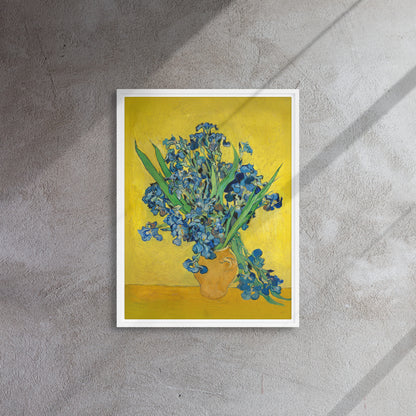 Van Gogh's 'Vase with Irises Against a Yellow Background' on a 18"x24" white framed canvas print on a textured gray wall.