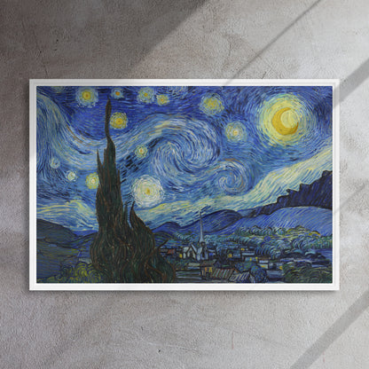 Van Gogh's 'Starry Night' on a 24"x36" white framed canvas print on a textured gray wall.