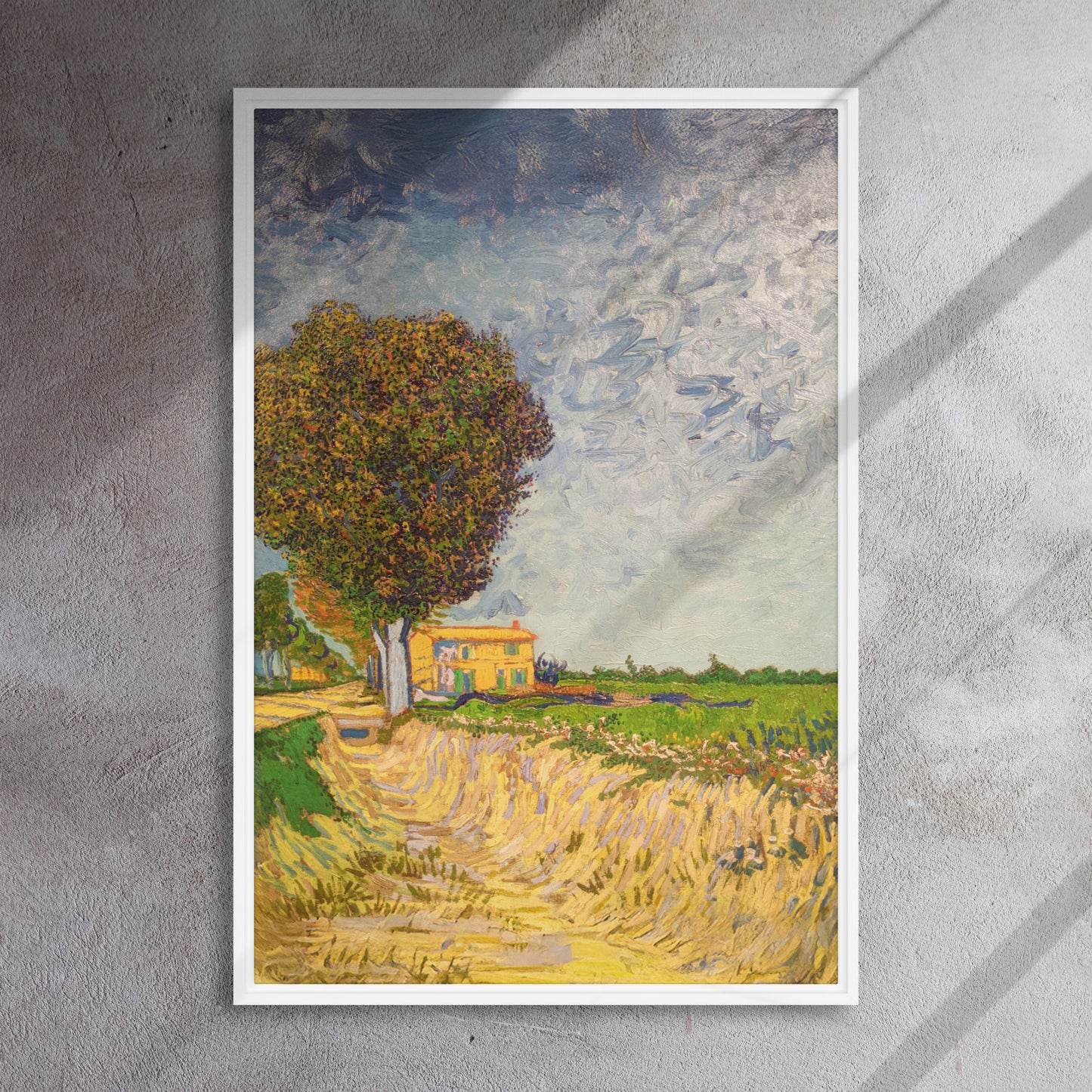 Van Gogh's 'A Lane near Arles' on a 24"x36" white framed canvas print on a textured gray wall.