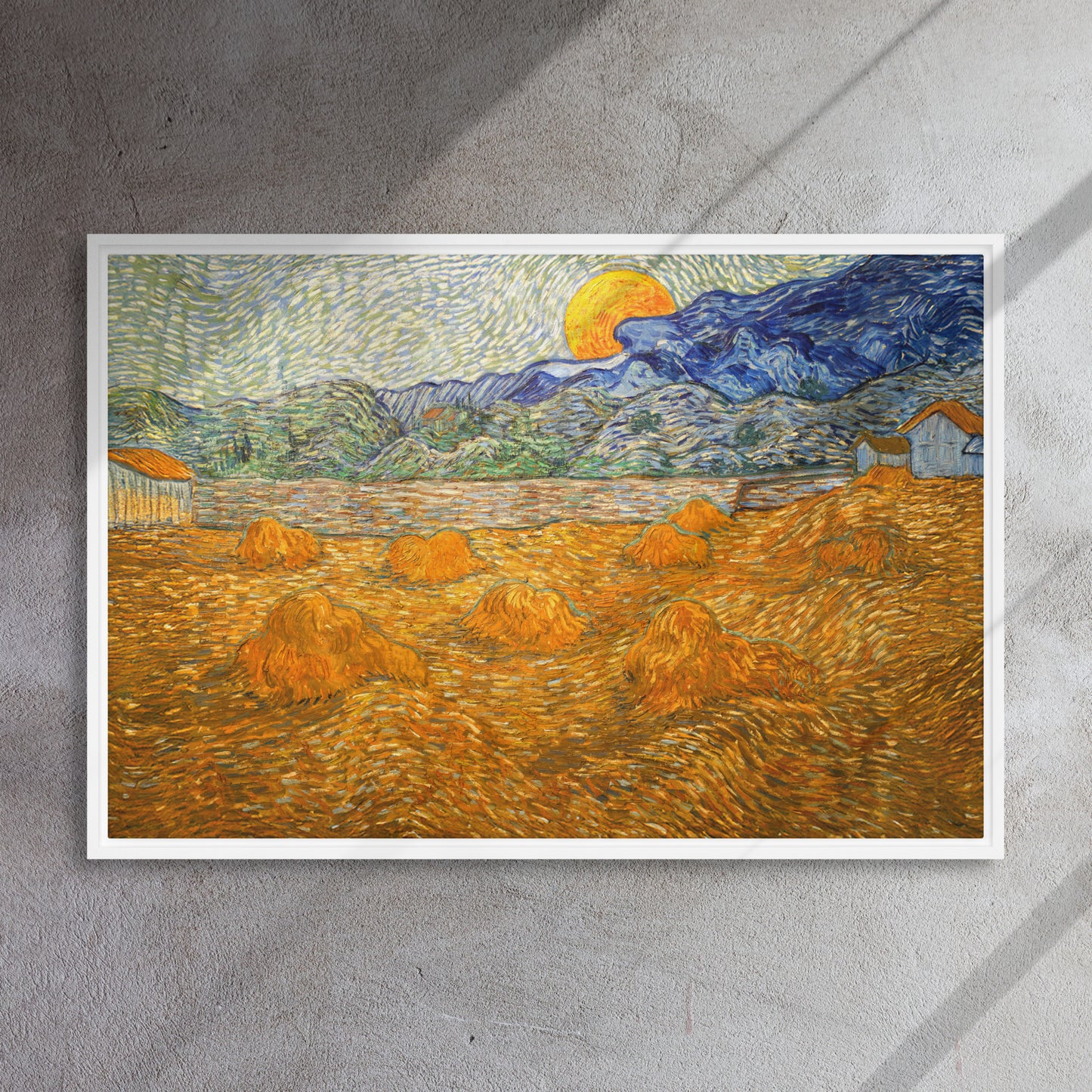 Van Gogh's 'Landscape with Wheat Sheaves and Rising Moon' on a 24"x36" white framed canvas print on a textured gray wall.