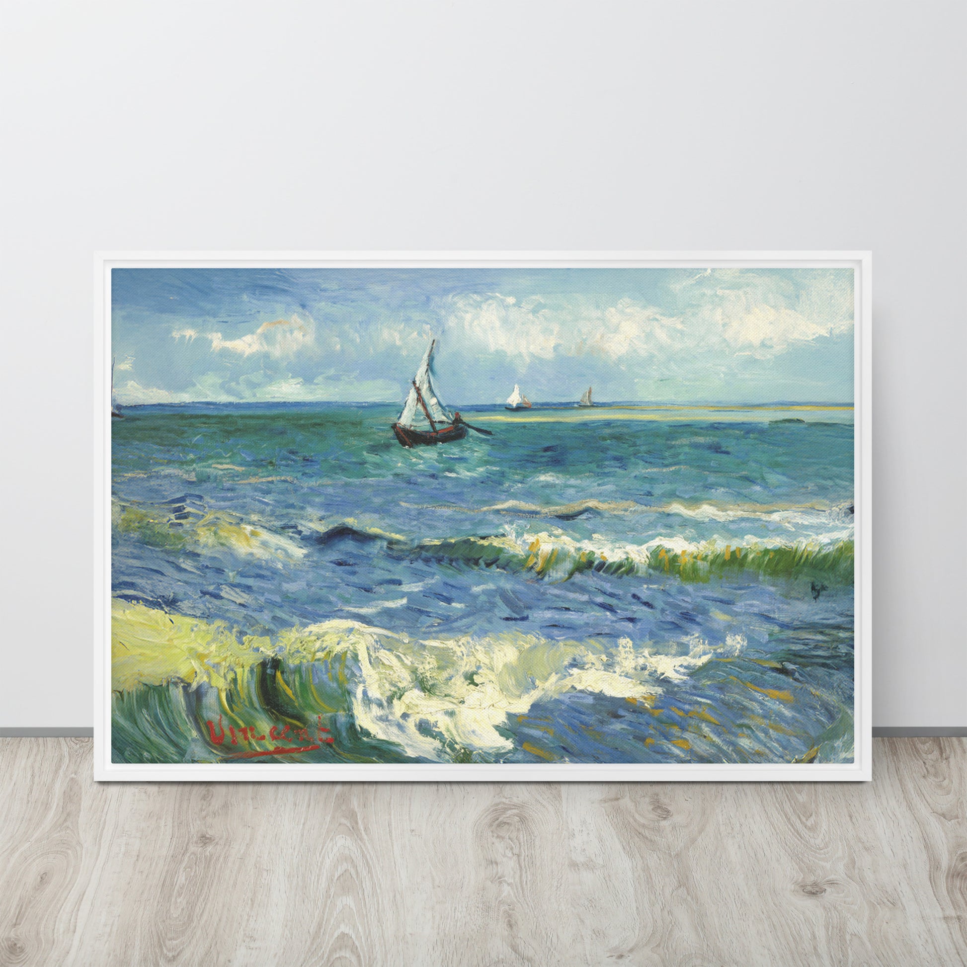 Van Gogh's 'The Sea at Les Saintes-Maries-de-la-Mer' on a 24"x36" white framed canvas print sitting on a wooden floor leaning against a light gray wall.
