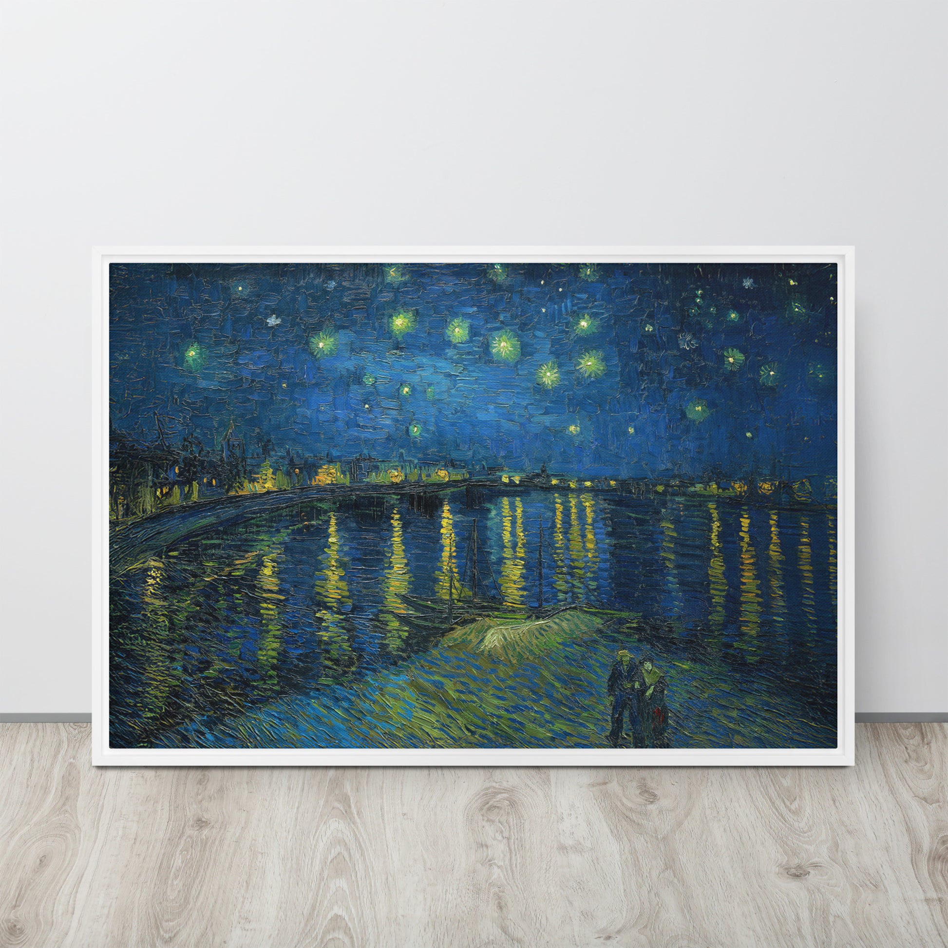 Van Gogh's 'Starry Night Over the Rhone' on a 24"x36" white framed canvas print sitting on a wooden floor leaning against a light gray wall.