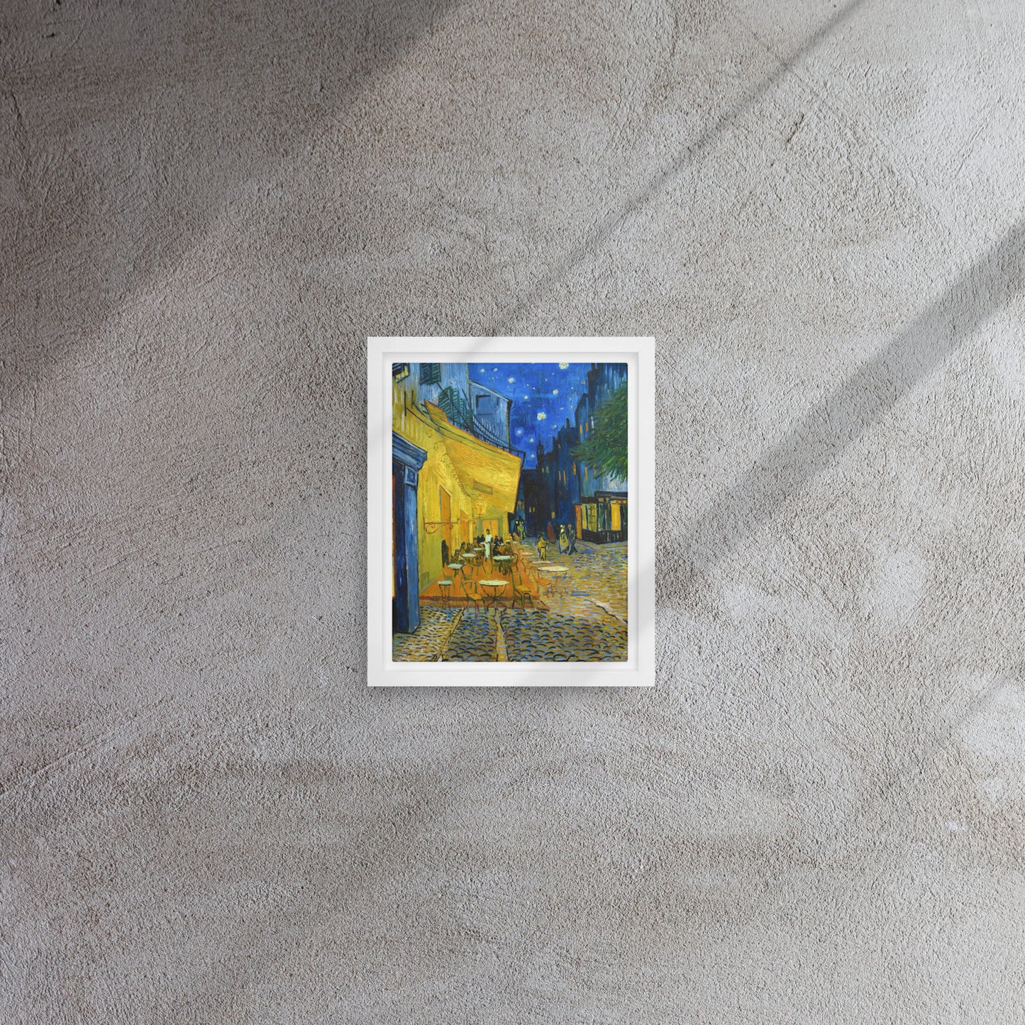 Van Gogh's 'Café Terrace at Night' on a 8"x10" white framed canvas print on a textured gray wall.