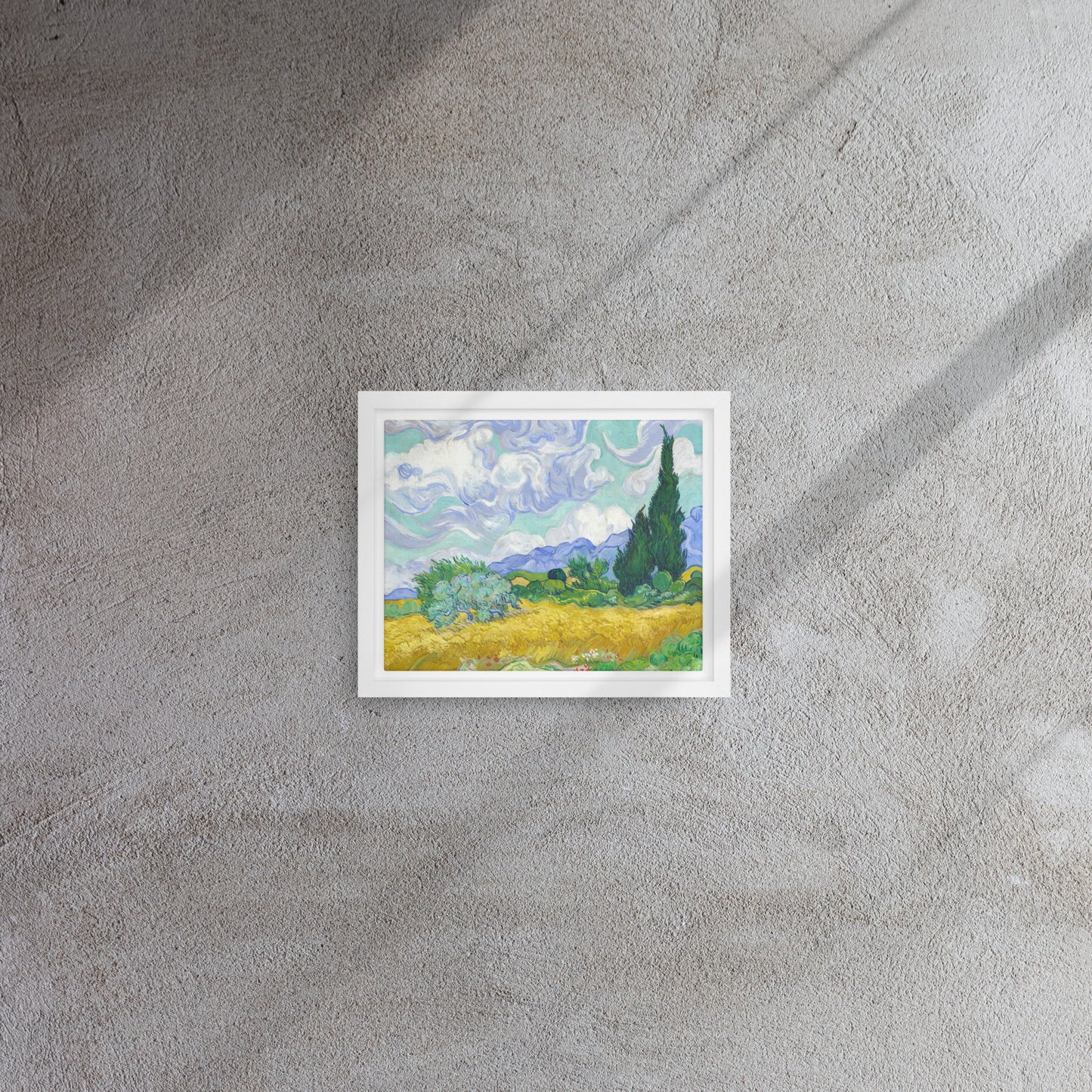 Van Gogh's 'Wheat Field with Cypresses' on a 8"x10" white framed canvas print on a textured gray wall.