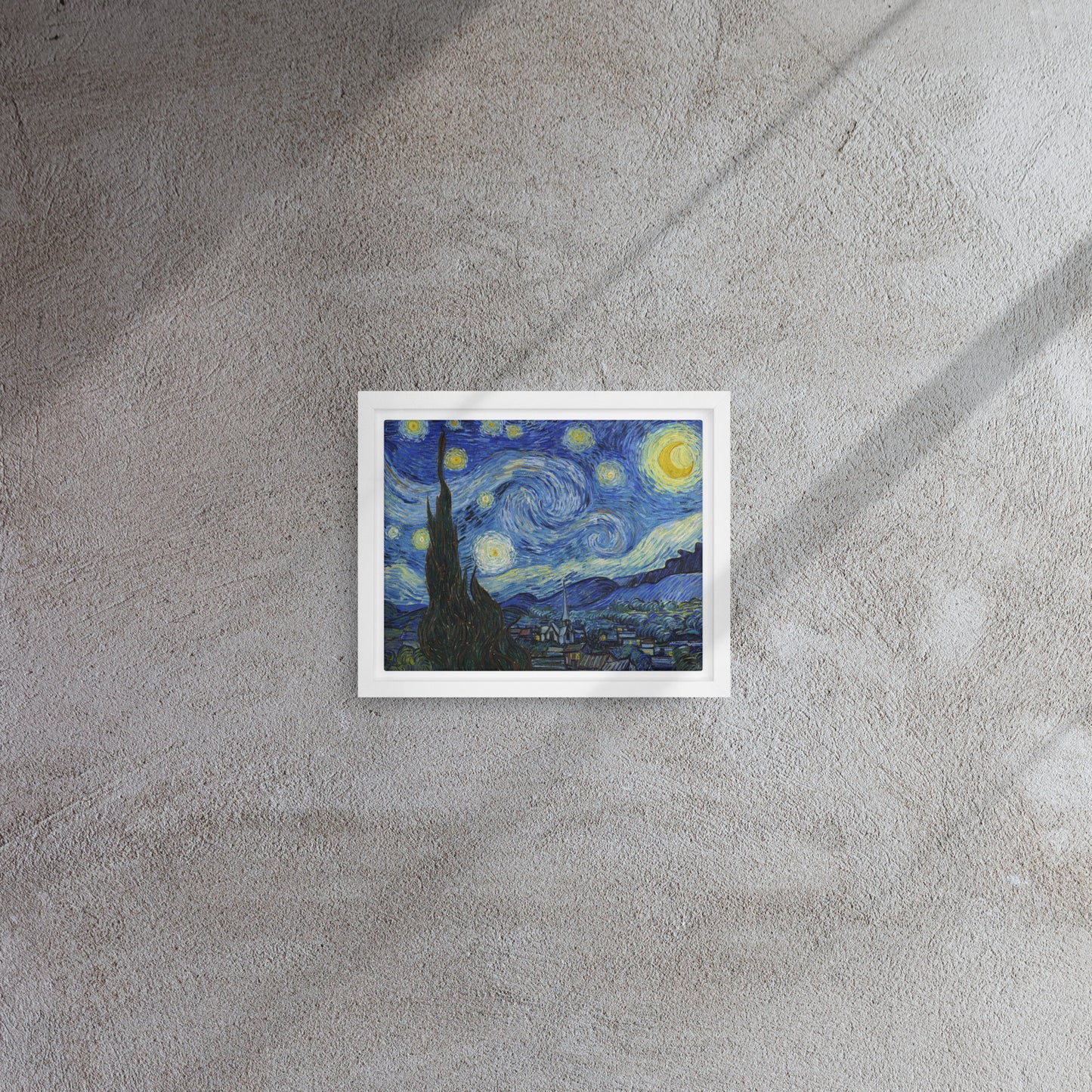 Van Gogh's 'Starry Night' on a 8"x10" white framed canvas print on a textured gray wall.