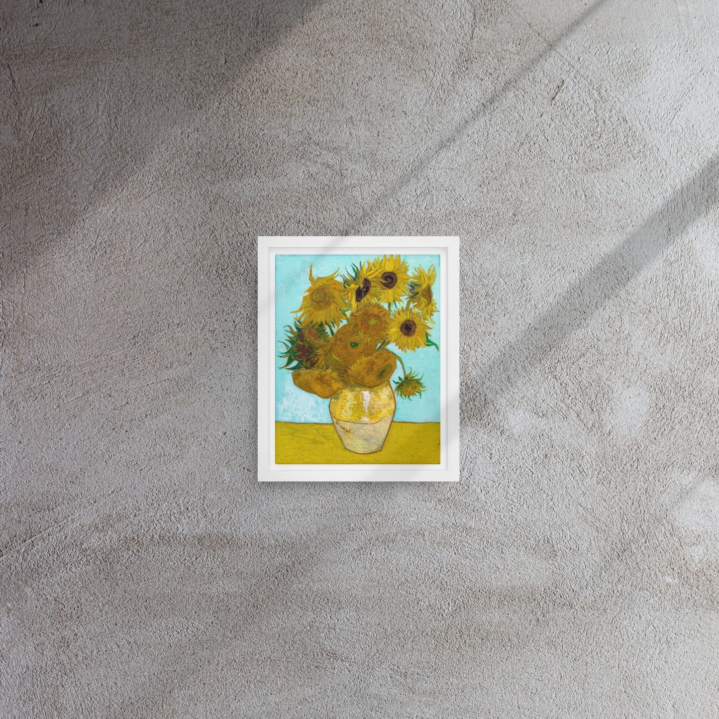 Van Gogh's 'Vase with Twelve Sunflowers' on a 8"x10" white framed canvas print on a textured gray wall.
