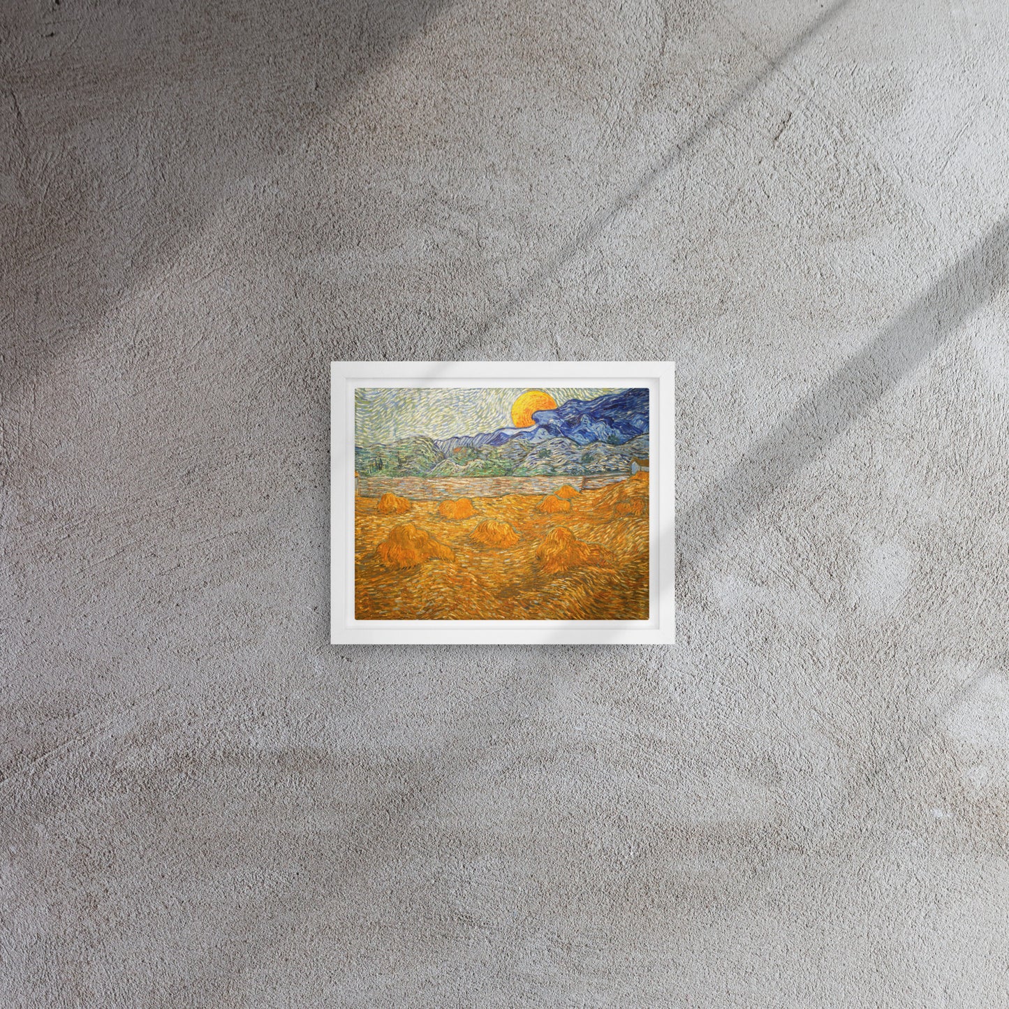 Van Gogh's 'Landscape with Wheat Sheaves and Rising Moon' on a 8"x10" white framed canvas print on a textured gray wall.